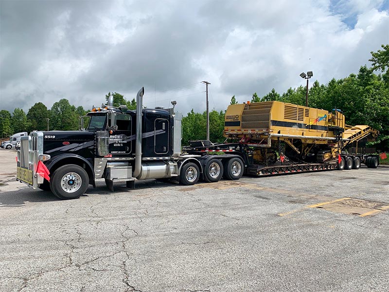Midstate Companies truck hauling a large milling machine.